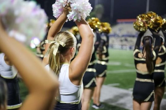 Royals cheer as they watch Servite's football games.