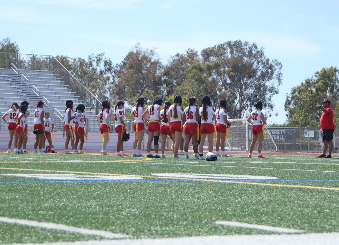 The flag football players huddle up during a game.