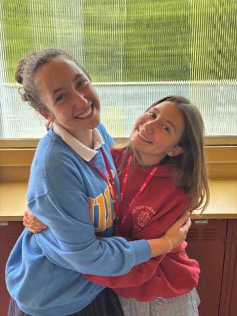 Seniors Christina Vaughan and Harper Clark share the love in their college sweatshirts.