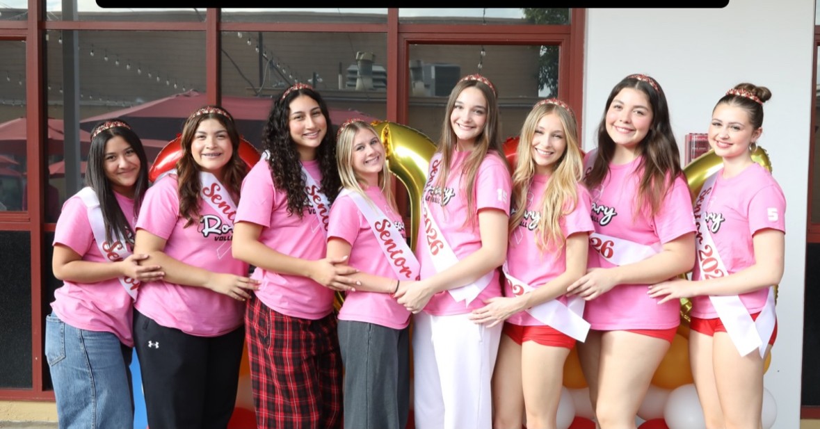 The volleyball seniors spreading awareness by wearing pink shirts during their game.
