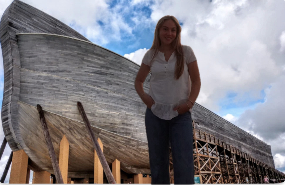 Emma stands proudly next to her latest build.