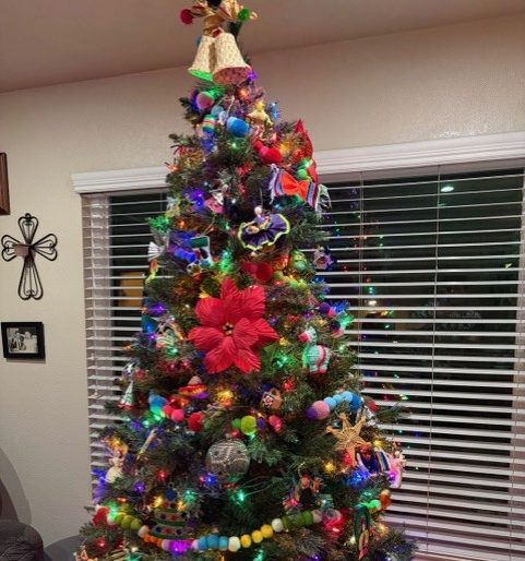 Mrs. Grasz's Christmas tree is so colorful with all the lights and flowers!