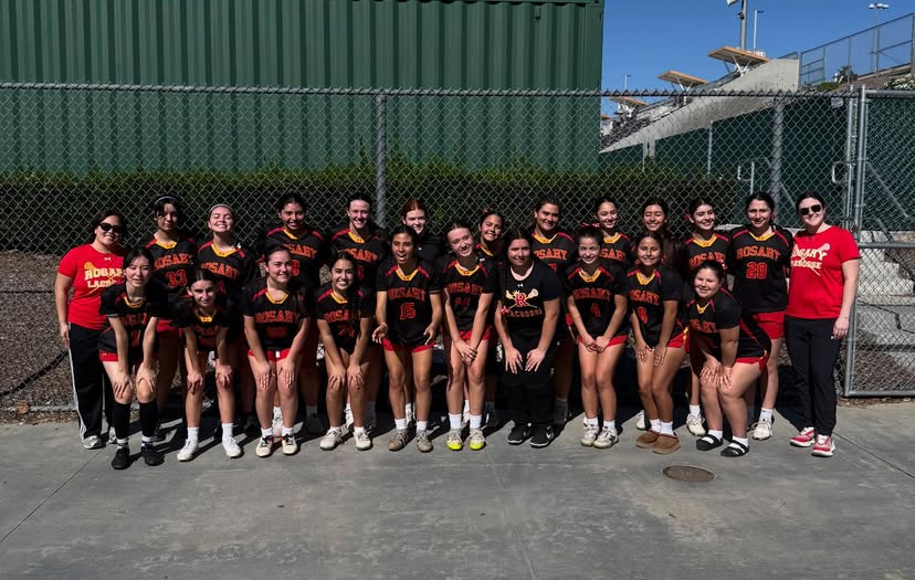 The lacrosse team smiles together after a great day at the Lax Town Rivals tournament.
